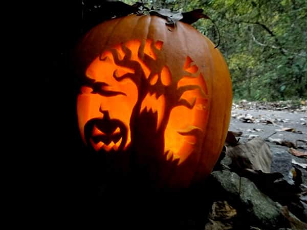 30. CARVE A TREE TERRORIZED BY A SMALLER PUMPKIN ON A PUMPKIN