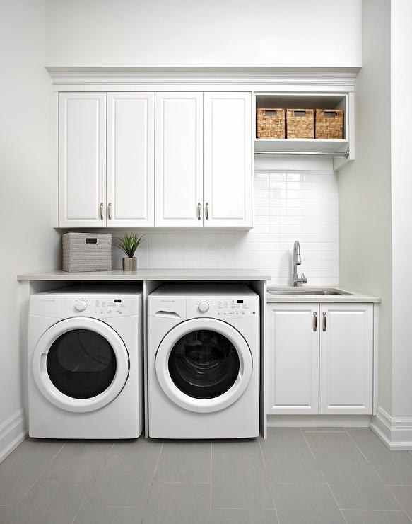 white modern laundry room clothes rod gray staggered floor tiles