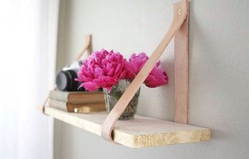 7. Attach two leather straps to the wall and use them to hold a wooden board