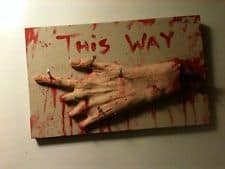 50. DECAPITATED HAND ON A SIGNBOARD