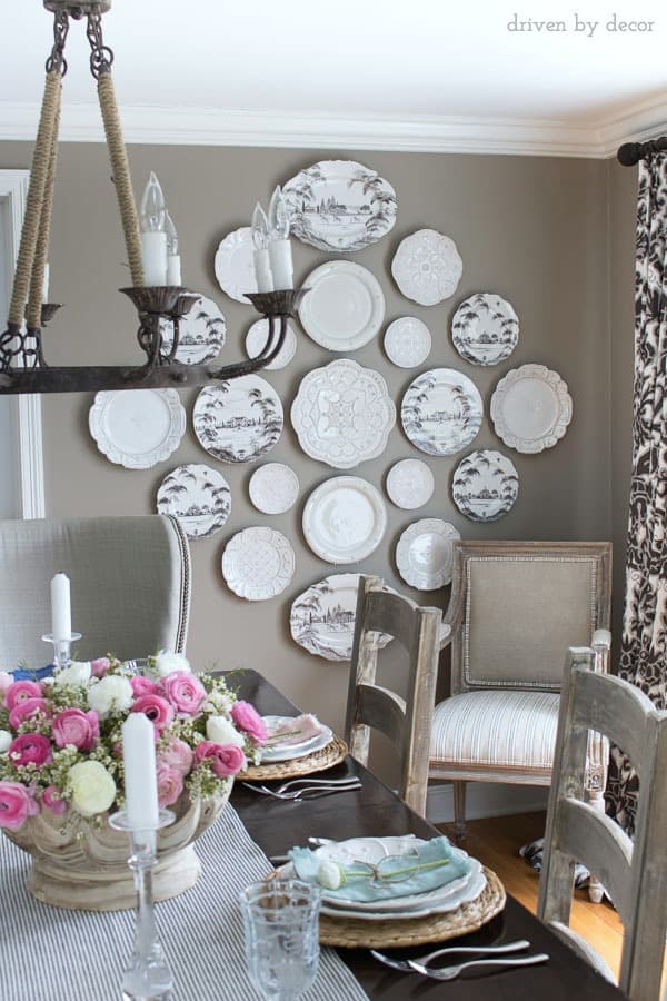 Dining room in neutrals with a statement making plate wall love