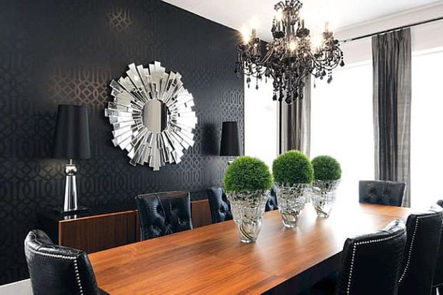 black themed dining room with sunburst mirror and luxury chandelier