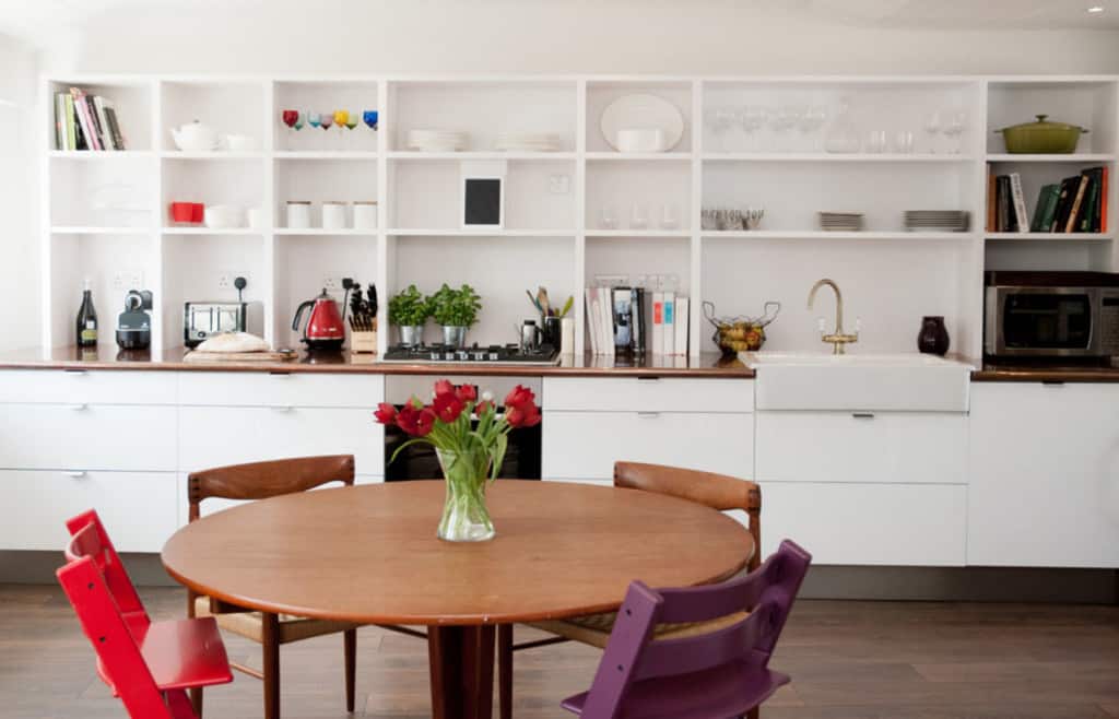modern kitchen round dining room mismatched chairs galley cabinets open shelving