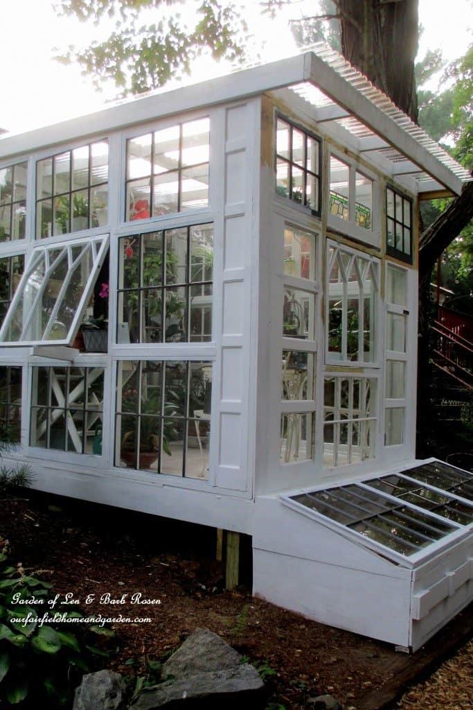 A BEAUTIFUL DIY GREENHOUSE MADE USING REPURPOSED WINDOWS