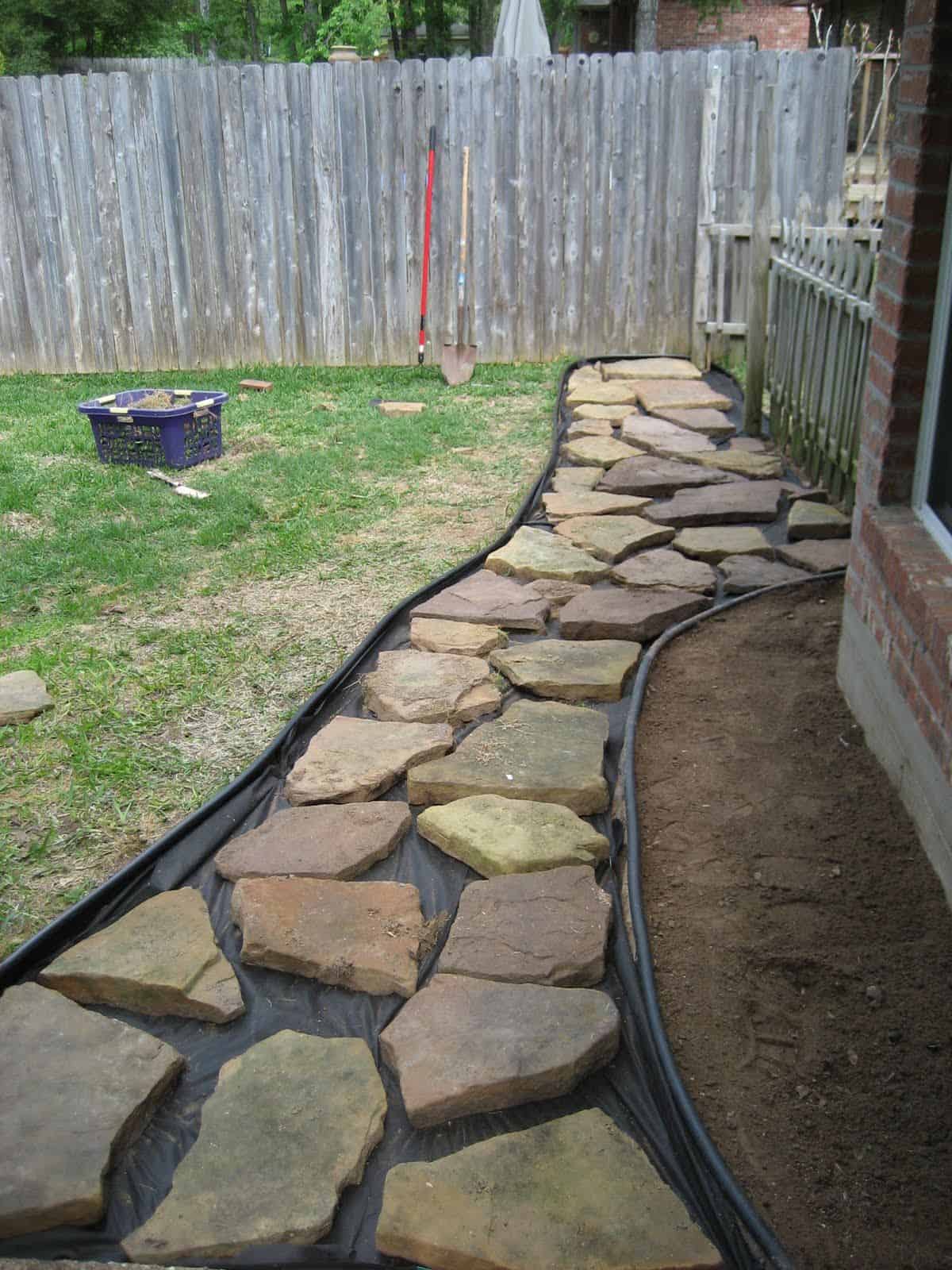 laying flagstone over concrete walkway inlaid grass paving