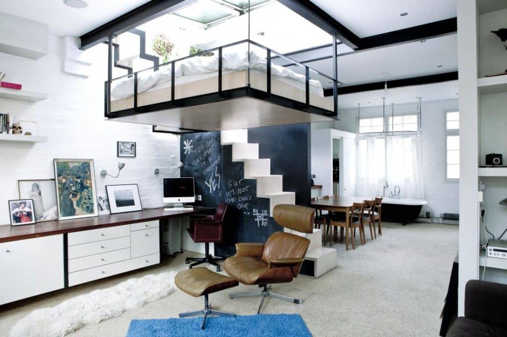 floating bed above a desk in a really small apartment 