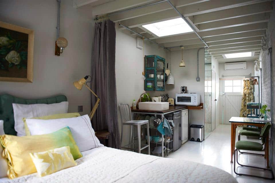 one room with small kitchenette, bedroom, living room in industrial vintage