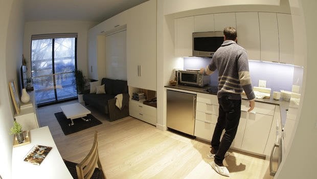 one room fits all in a small white efficiency apartment