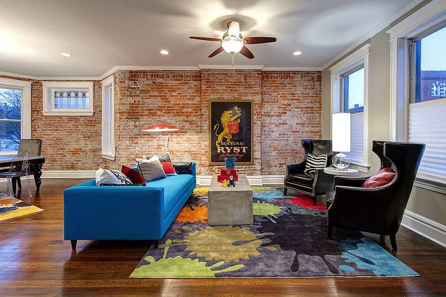 Colorful couch in blue rug and plush chairs make a vivacious living room