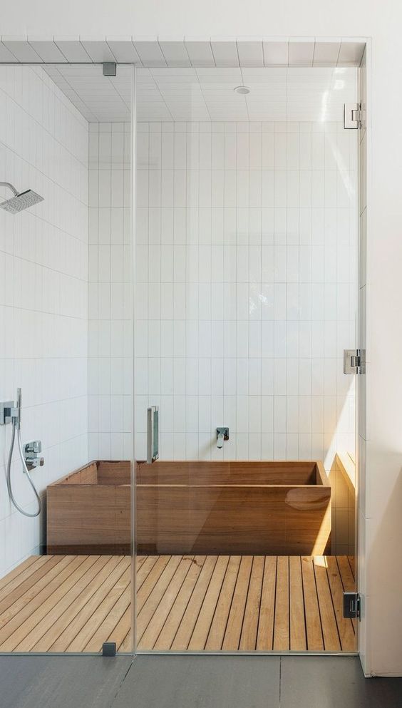 37. White Bathroom With Wooden Bathtub & Flooring