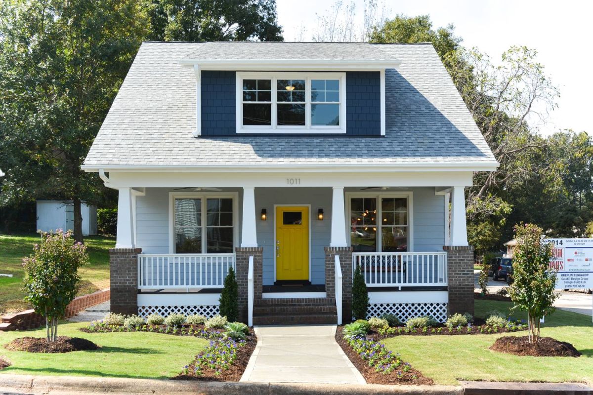 Craftsman cottage yellow door brick columns