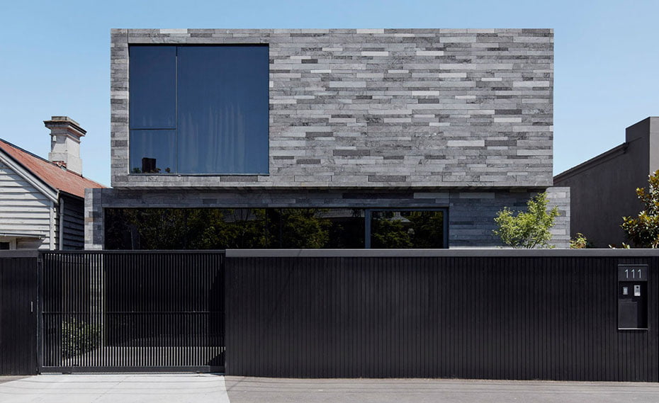 front facing large format lavastone strip veneer facade