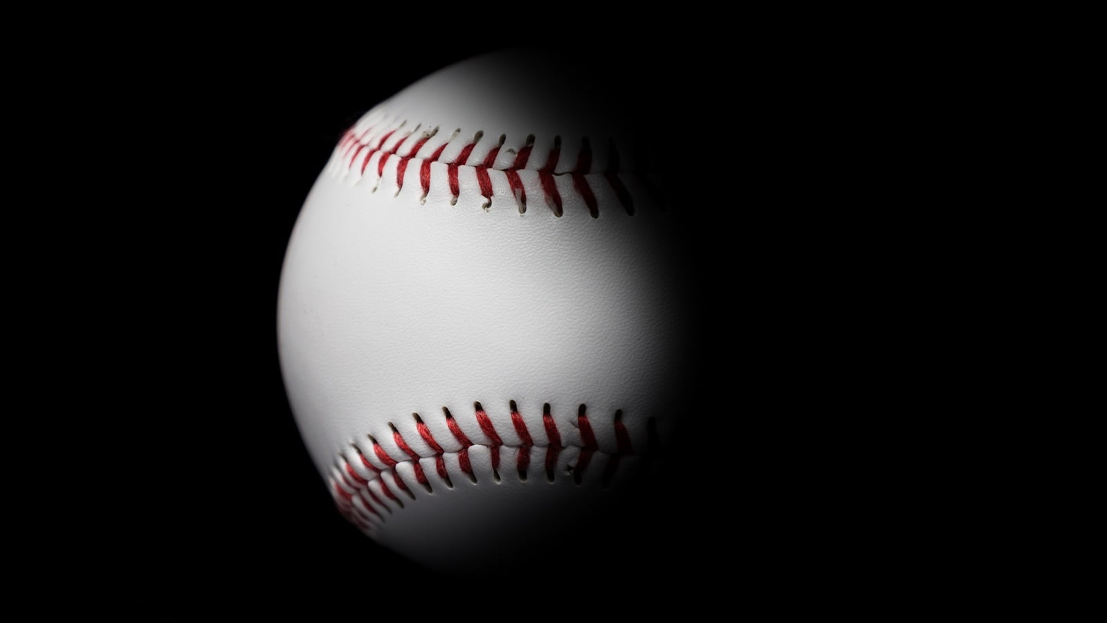 Baseball in black background.