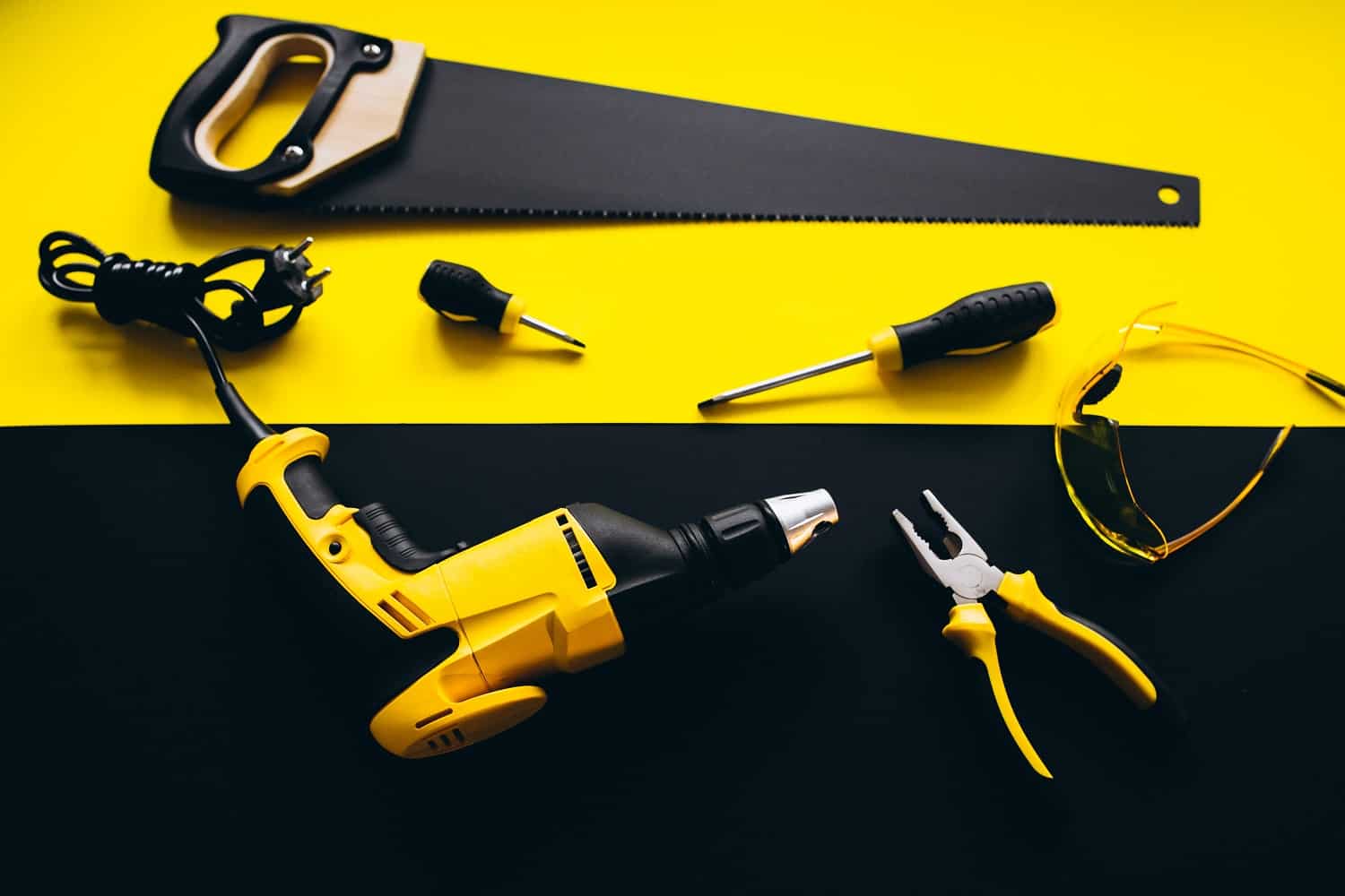 Set of yellow tools on a black and yellow background