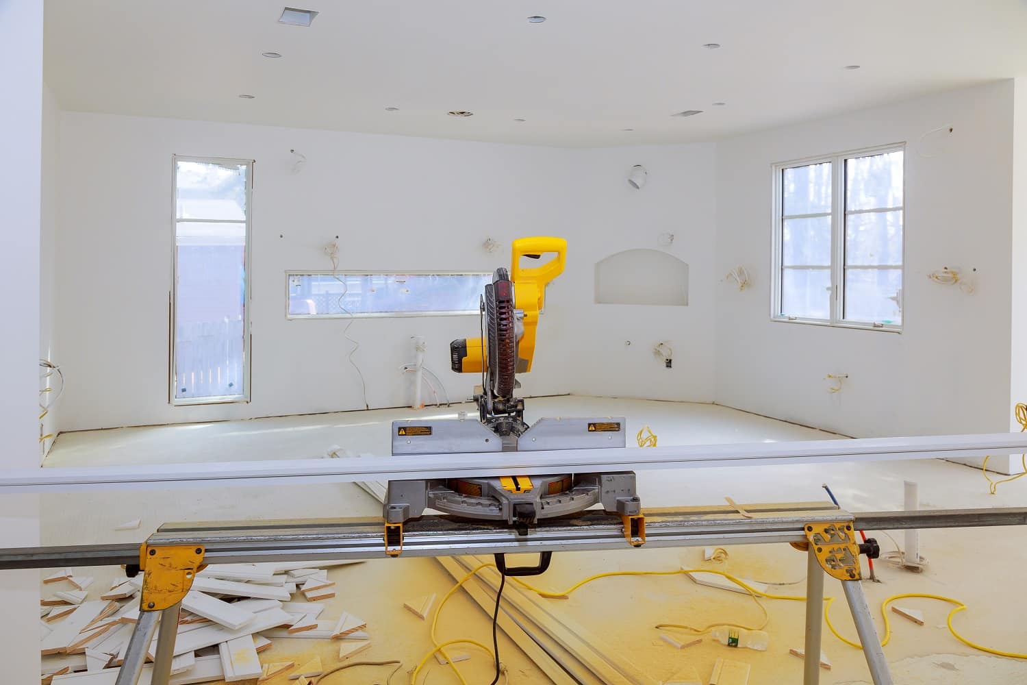 Contractor uses a circular saw to cut trim molding saw on a construction site