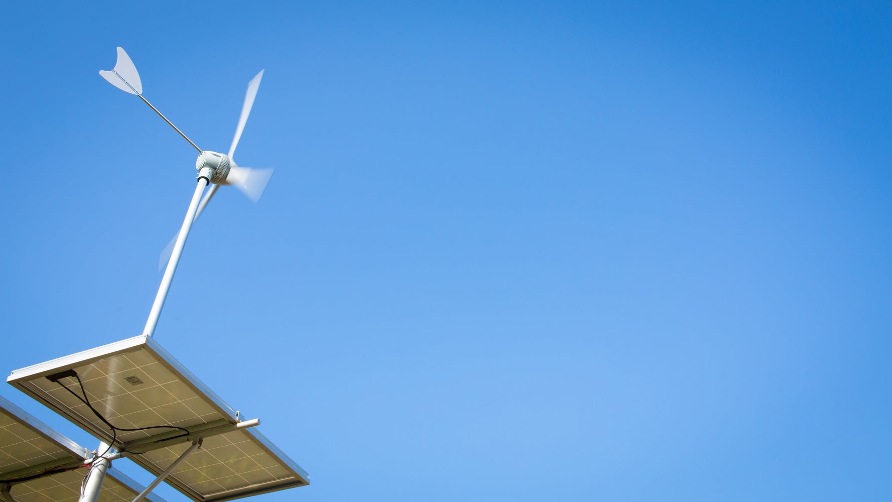 Wind turbine over blue sky