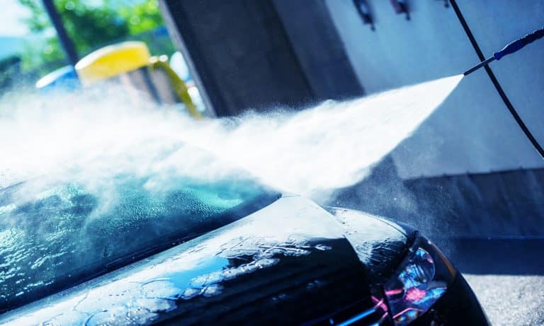 Hand Car Wash Cleaning. Bluish Color Grading. Cleaning Modern Compact Car.