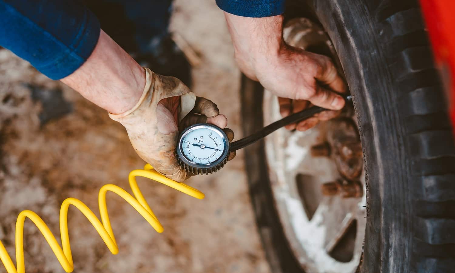 A man pumps air wheel with a compressor on the road. Makita MAC2400 Air Compressor Review