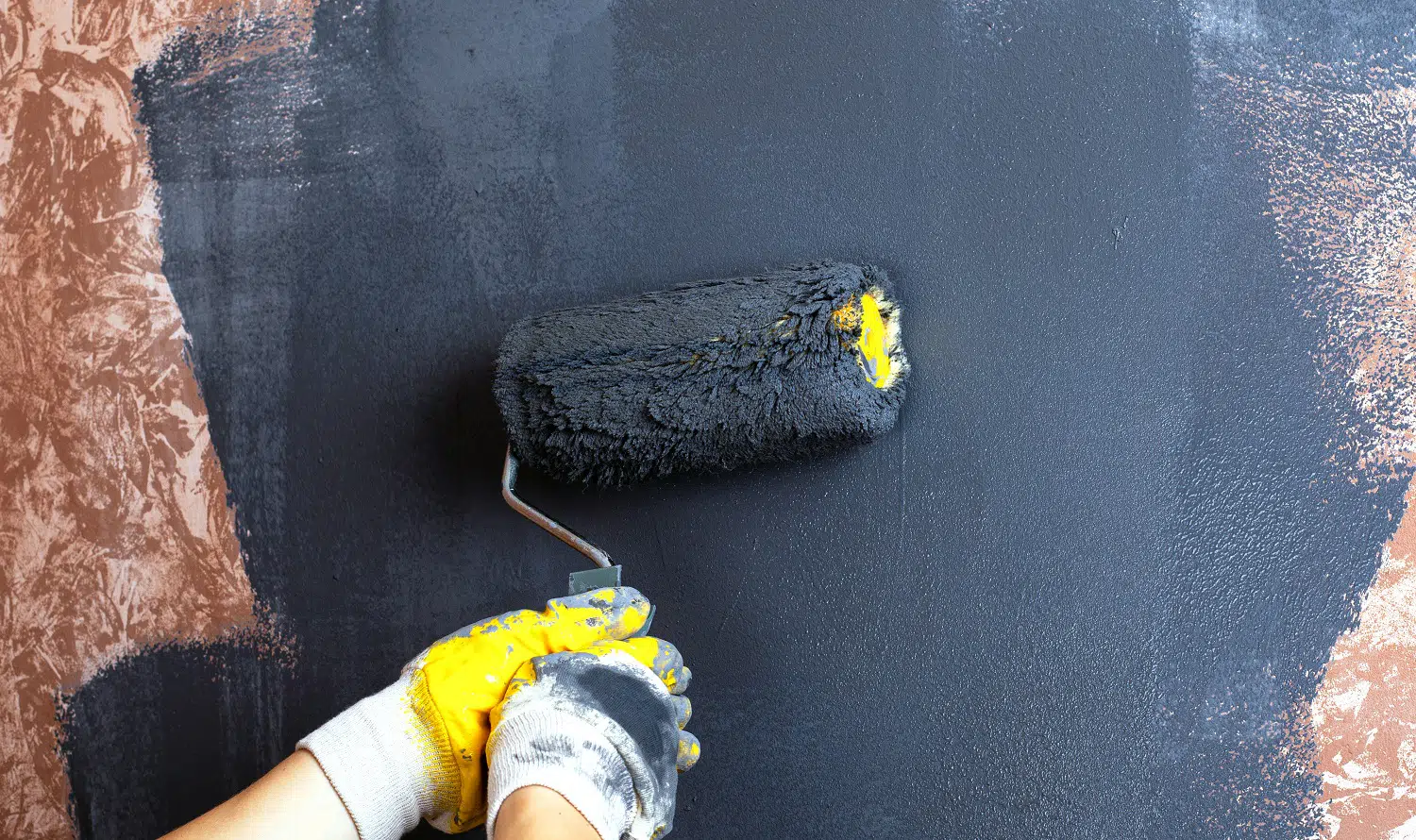 hand paint the walls with a roller gray color. apartment repair concept. Best Concrete Paints