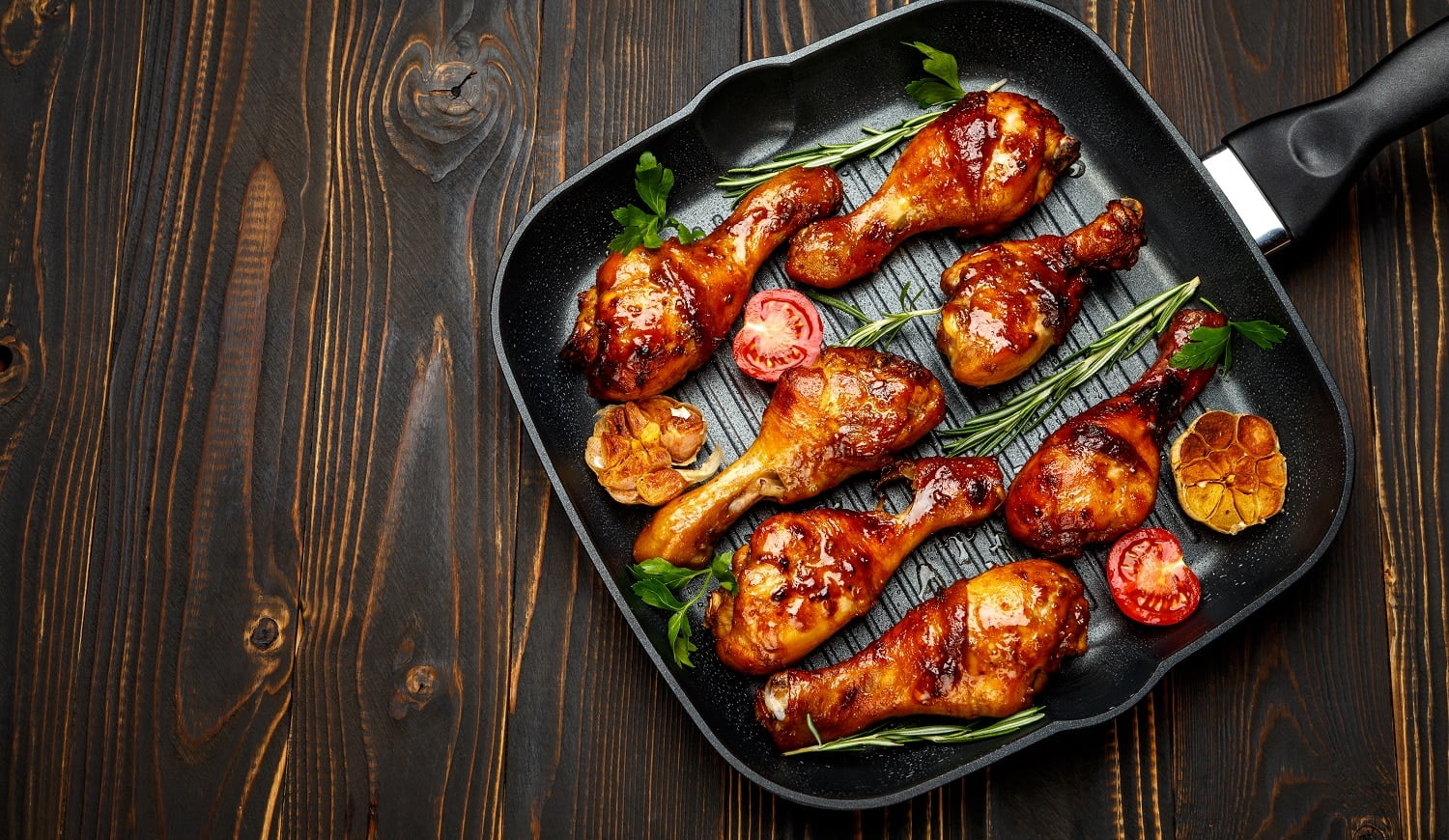 roasted chicken legs with herbs on wooden table