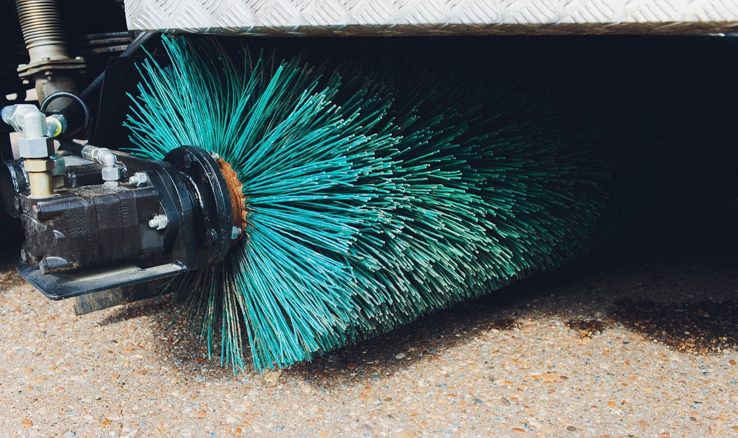 Close up shot of a road brush sweeping machine