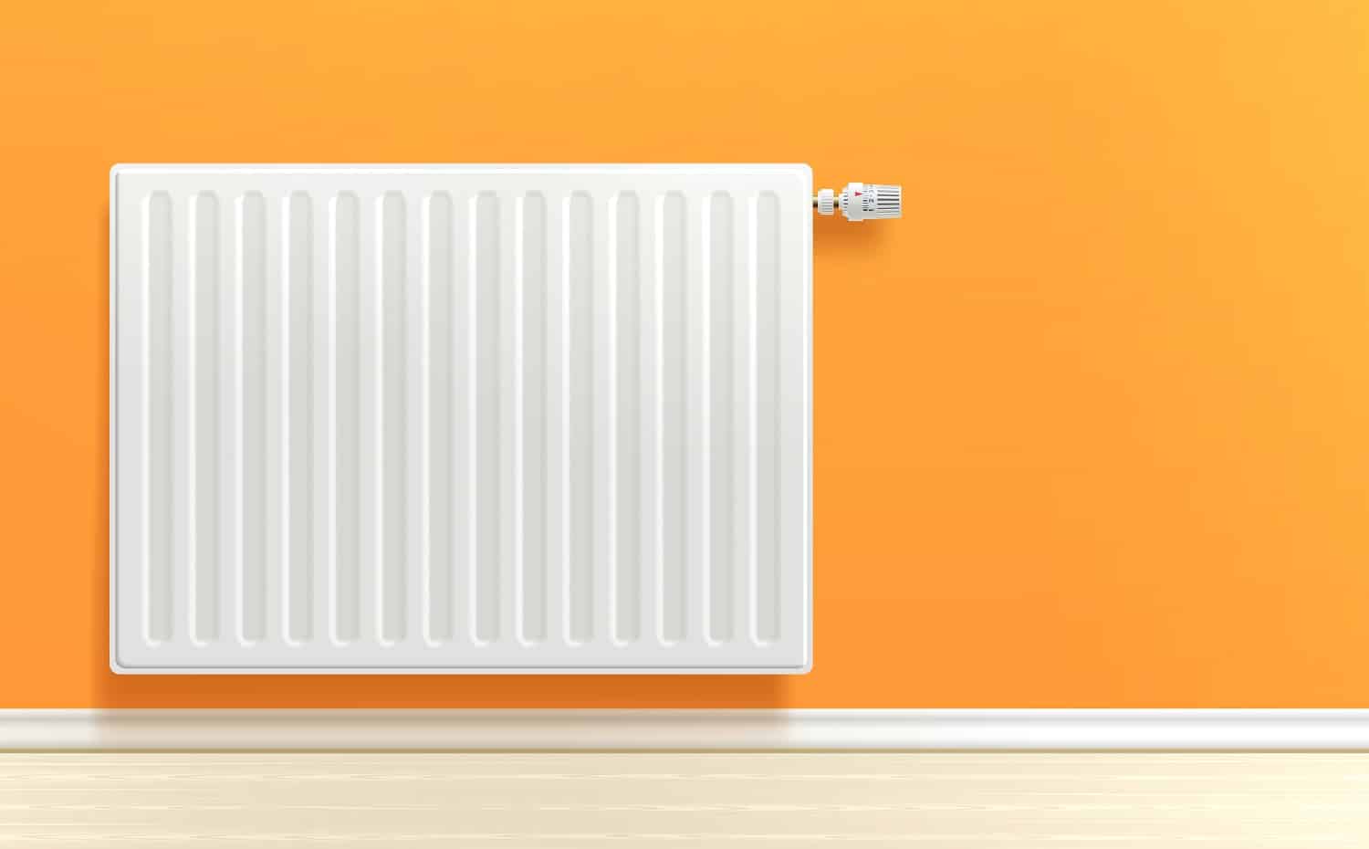 Realistic white heating radiator on orange room wall vector illustration