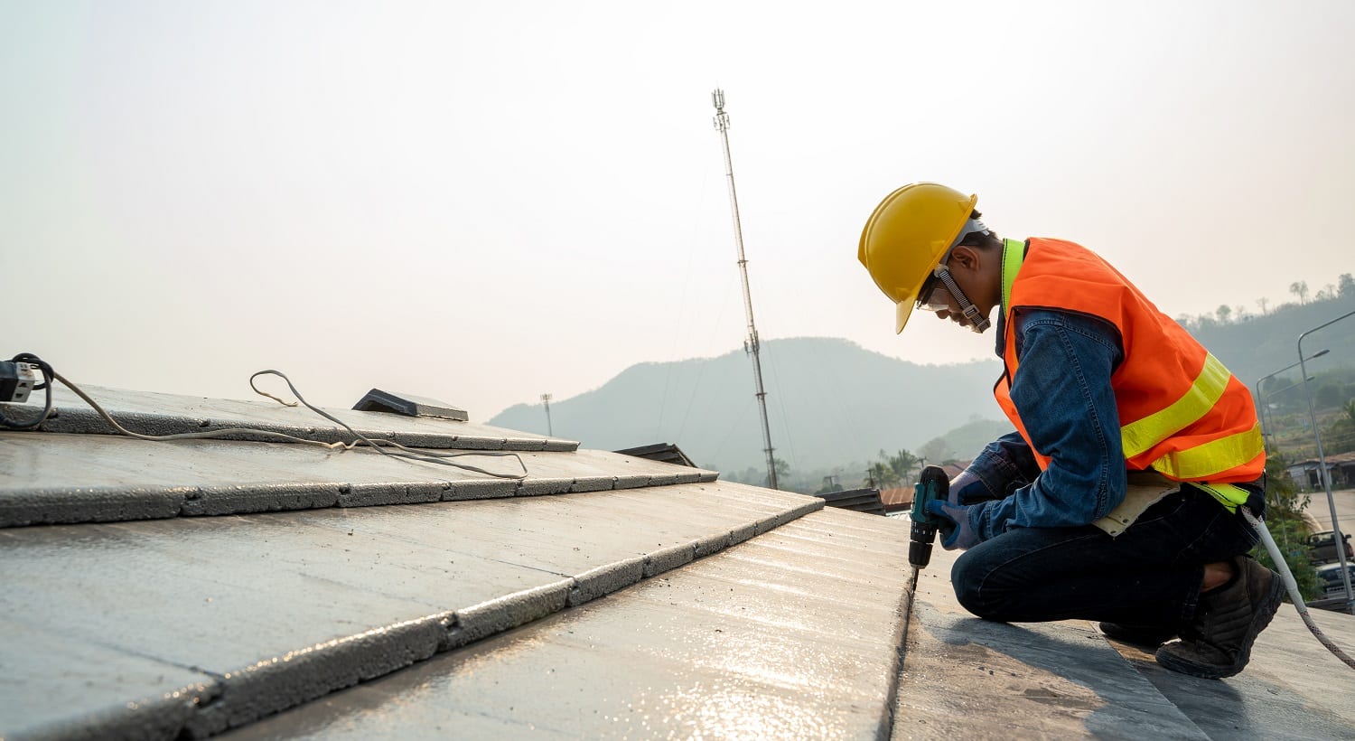 Construction engineer wear safety uniform inspection roofer working on roof structure of building on construction site.