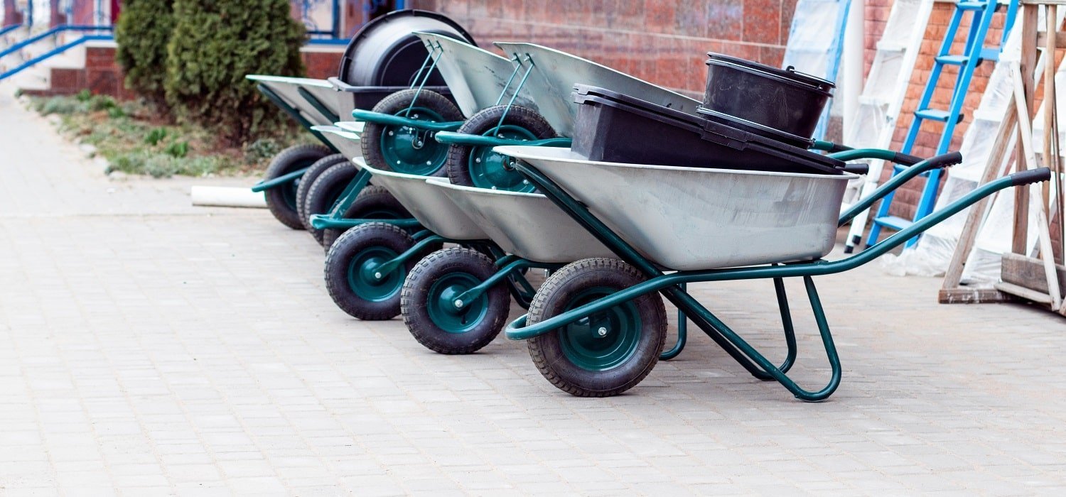 Garden and vegetable garden concept. Garden wheelbarrows outdoor for sale in spring season