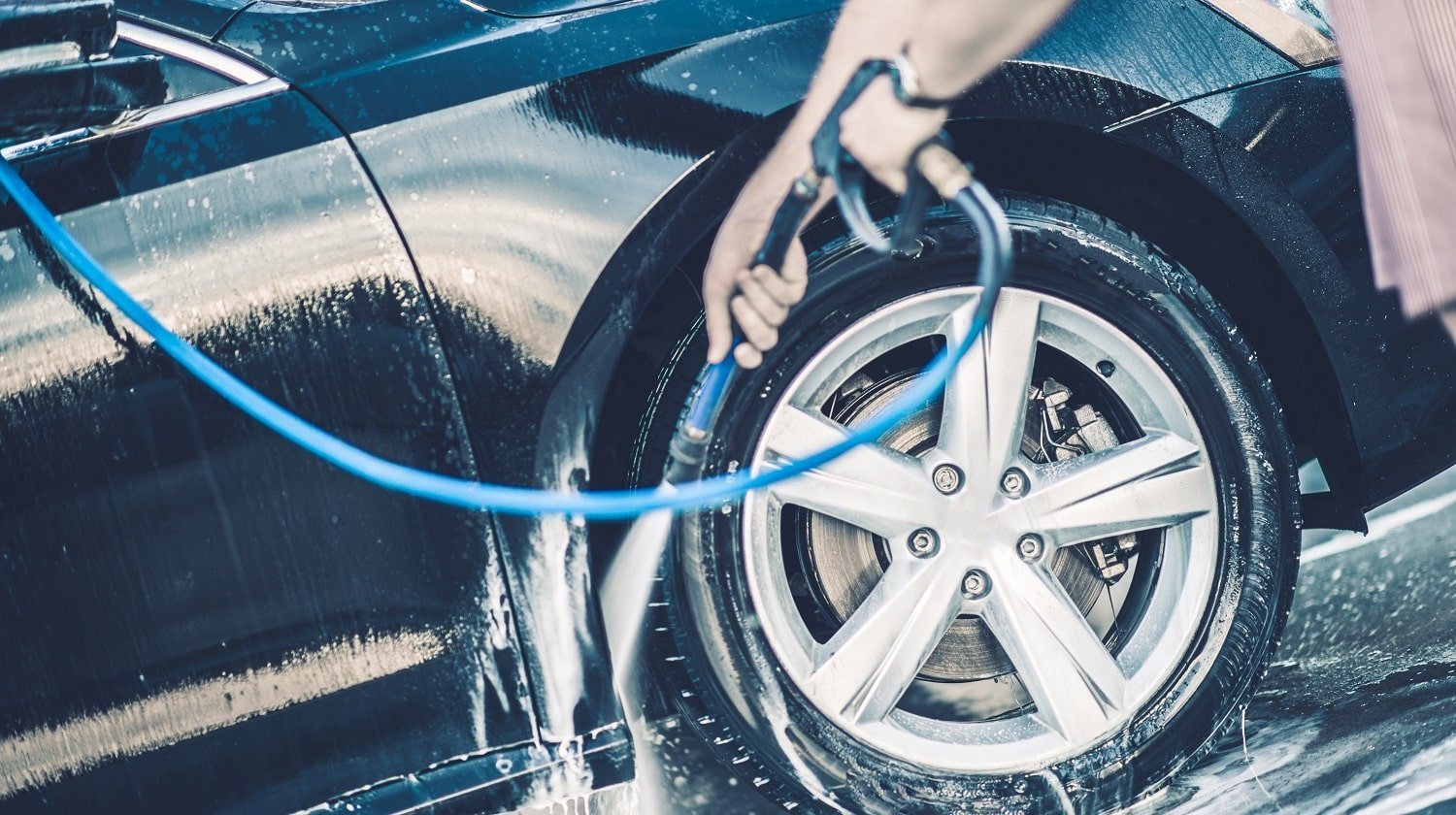 Self Car Washing. Cleaning Wheels Using High Pressure Water.