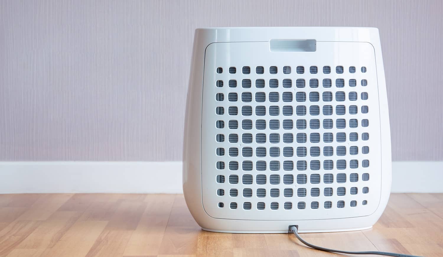 Modern portable air purifier in the room close up.