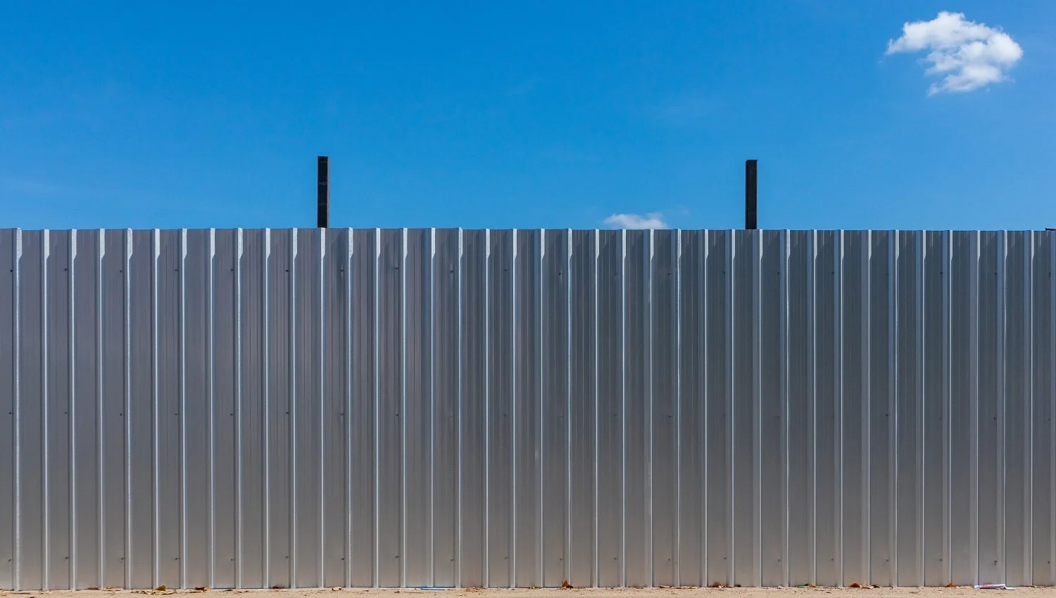Clean aluminium fence to protect construction area.