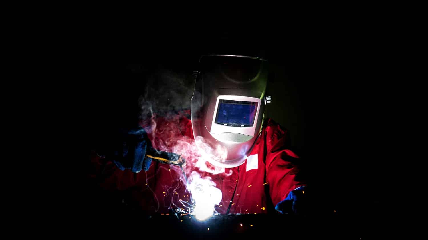 Industrial Worker at the factory welding closeup, welder Industrial automotive part in factory, selective focus