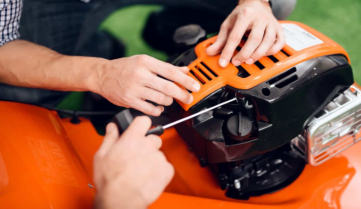 A man starts a lawnmower motor in the store.