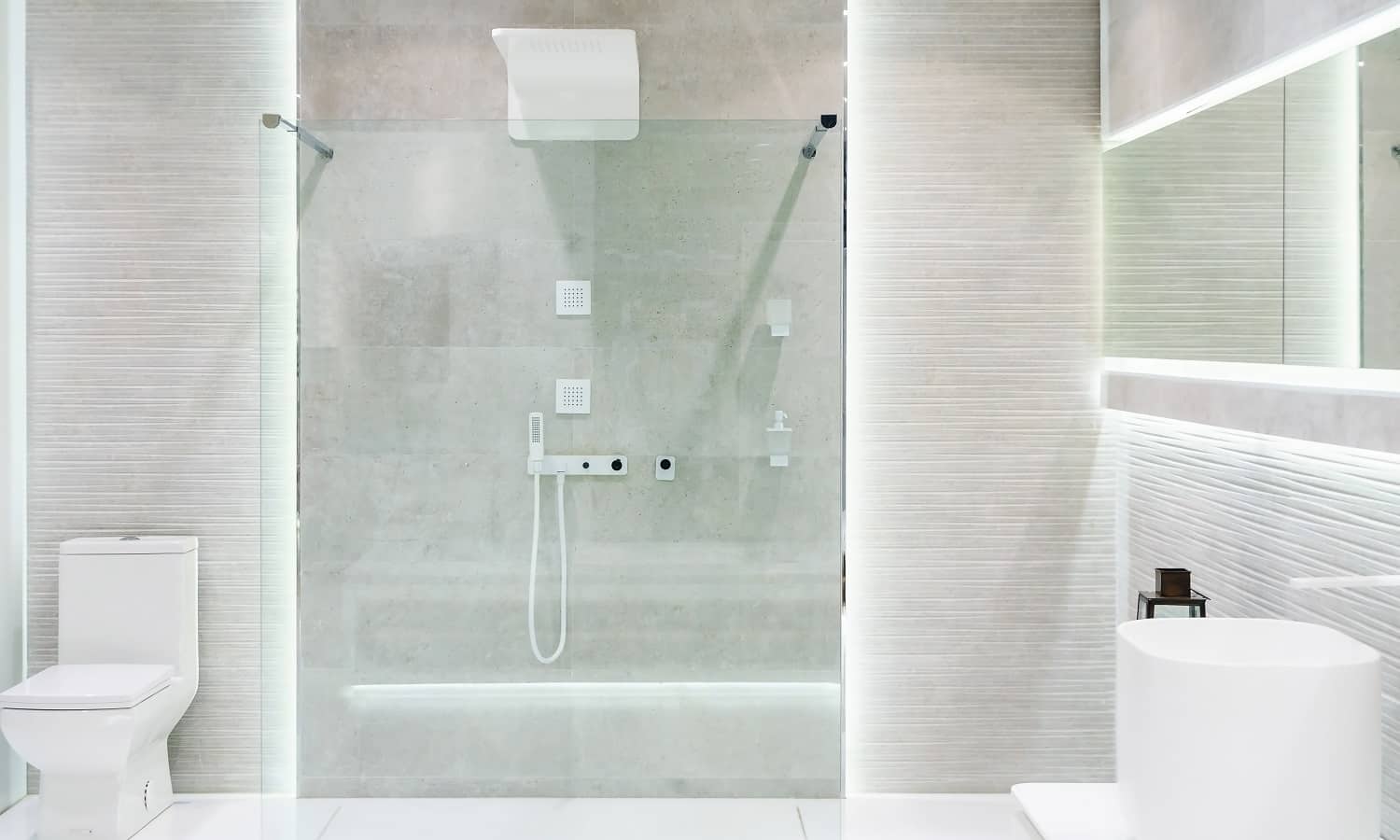 Bathroom interior with white walls, a shower cabin with glass wall, a toilet and sink
