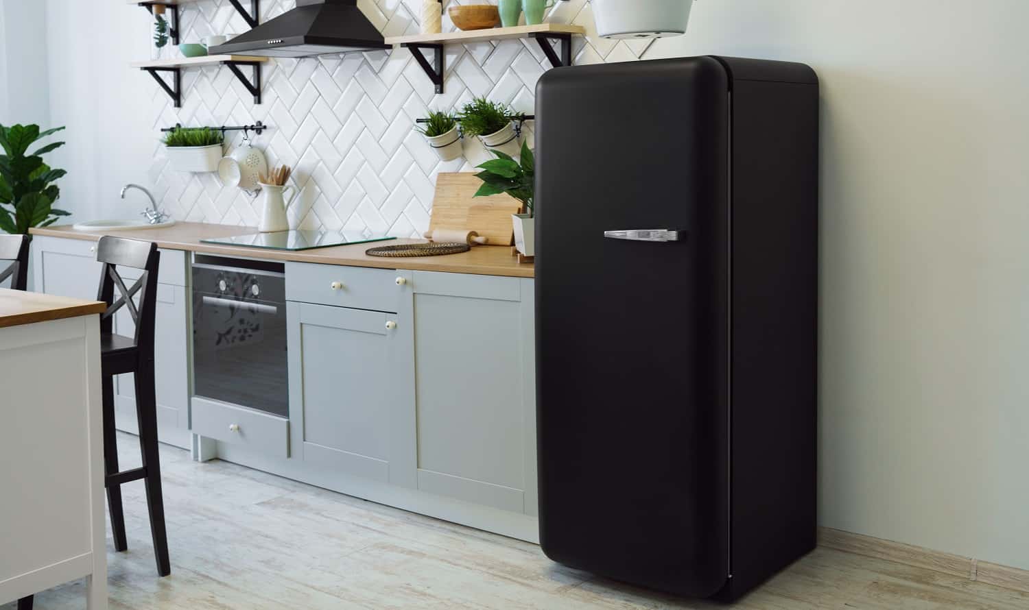 Retro black fridge in gray wooden kitchen