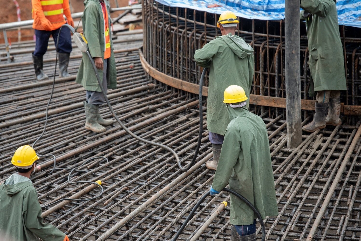 Construction worker pouring a concrete at mass foundation