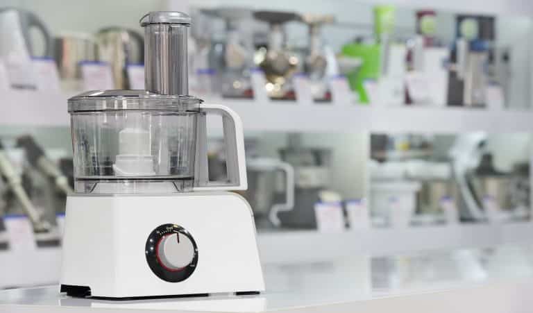 single electric food processor at retail store shelf, defocused background