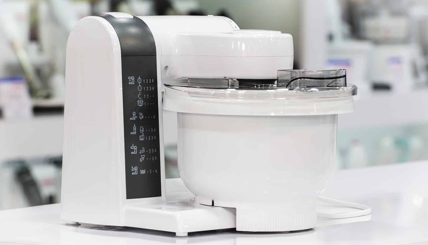 single electric food processor at retail store shelf, defocused background