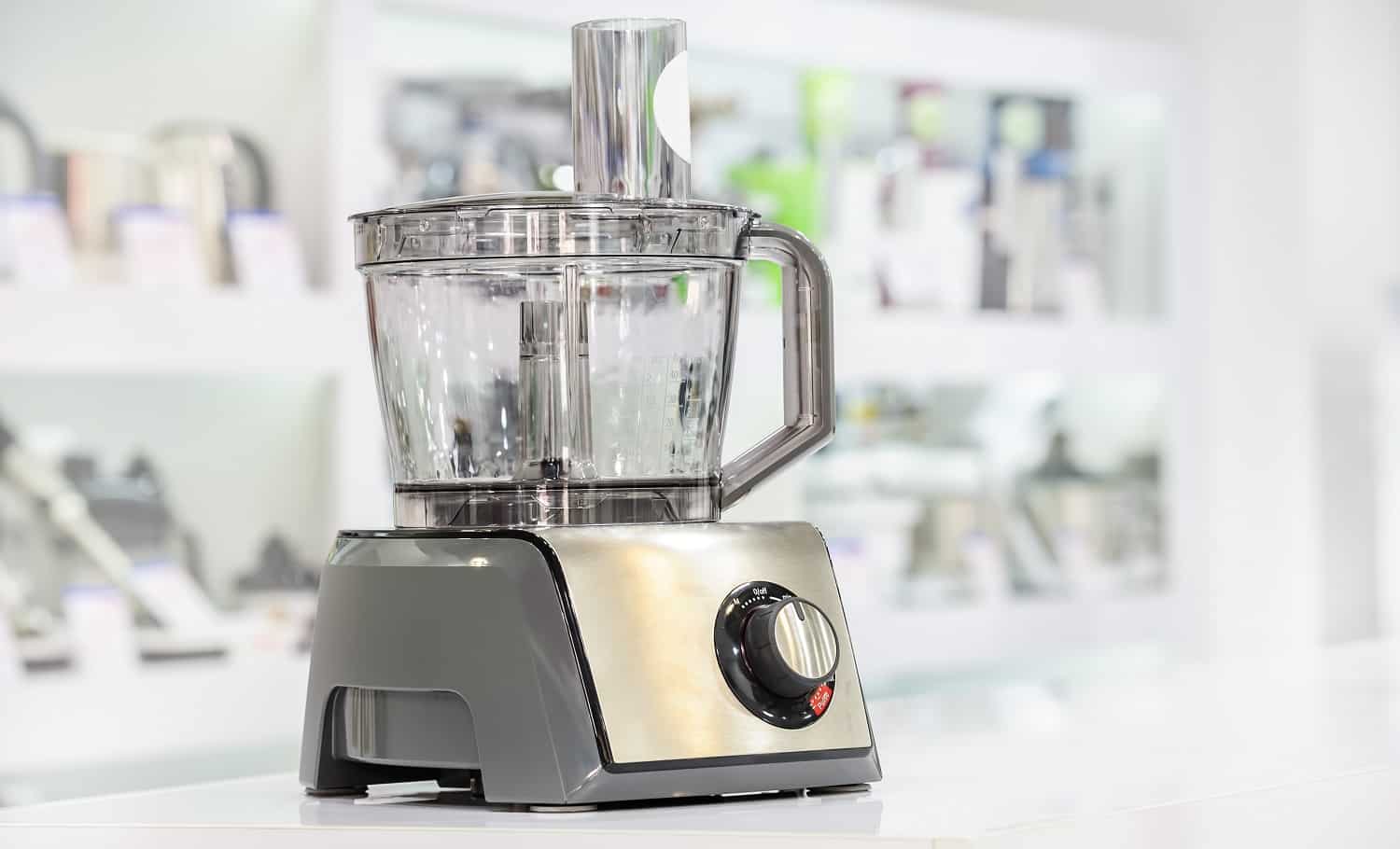 single electric food processor at retail store shelf, defocused background