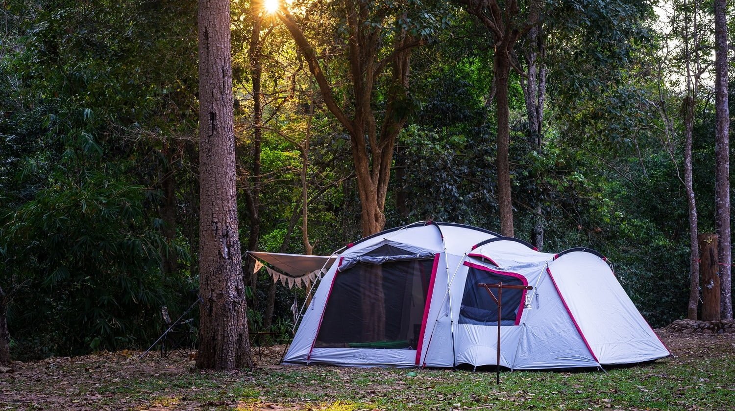 Camping and tent in nature park with sunset