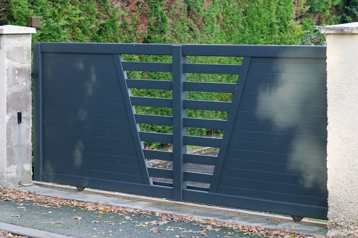 Aluminum gray sliding portal of suburb house. Buying Guide for a Top Gate Opener