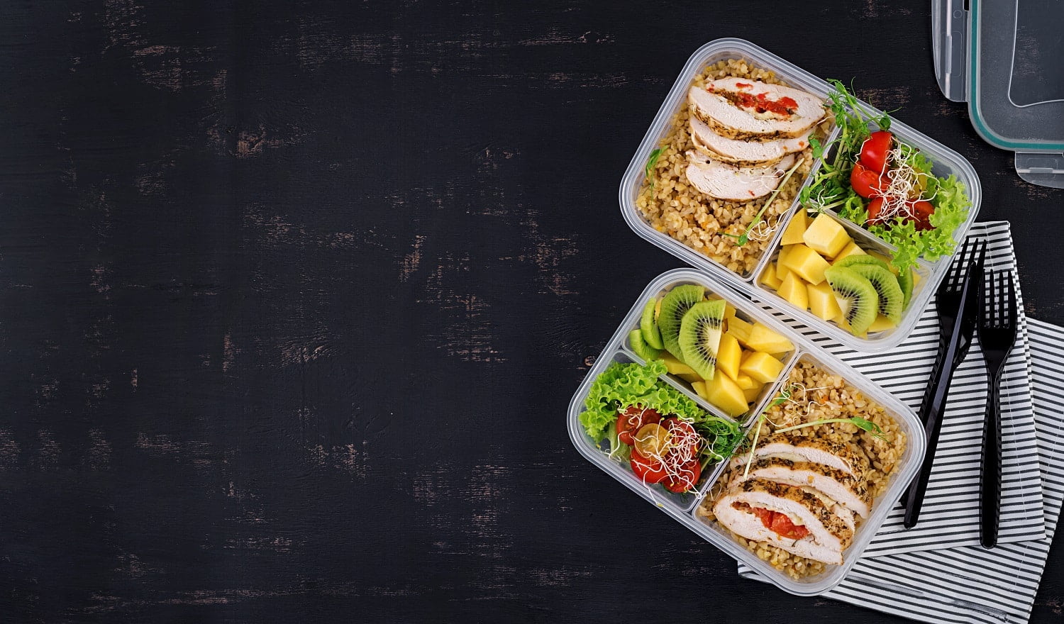Lunch box chicken, bulgur, microgreens, tomato and fruit. Healthy fitness food. Take away. Lunchbox. Top view