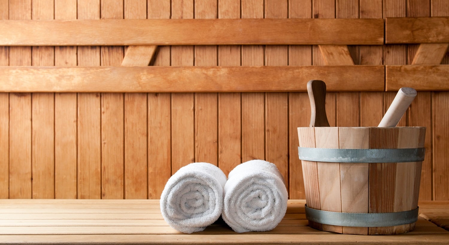 Detail of bucket and white towels in a sauna