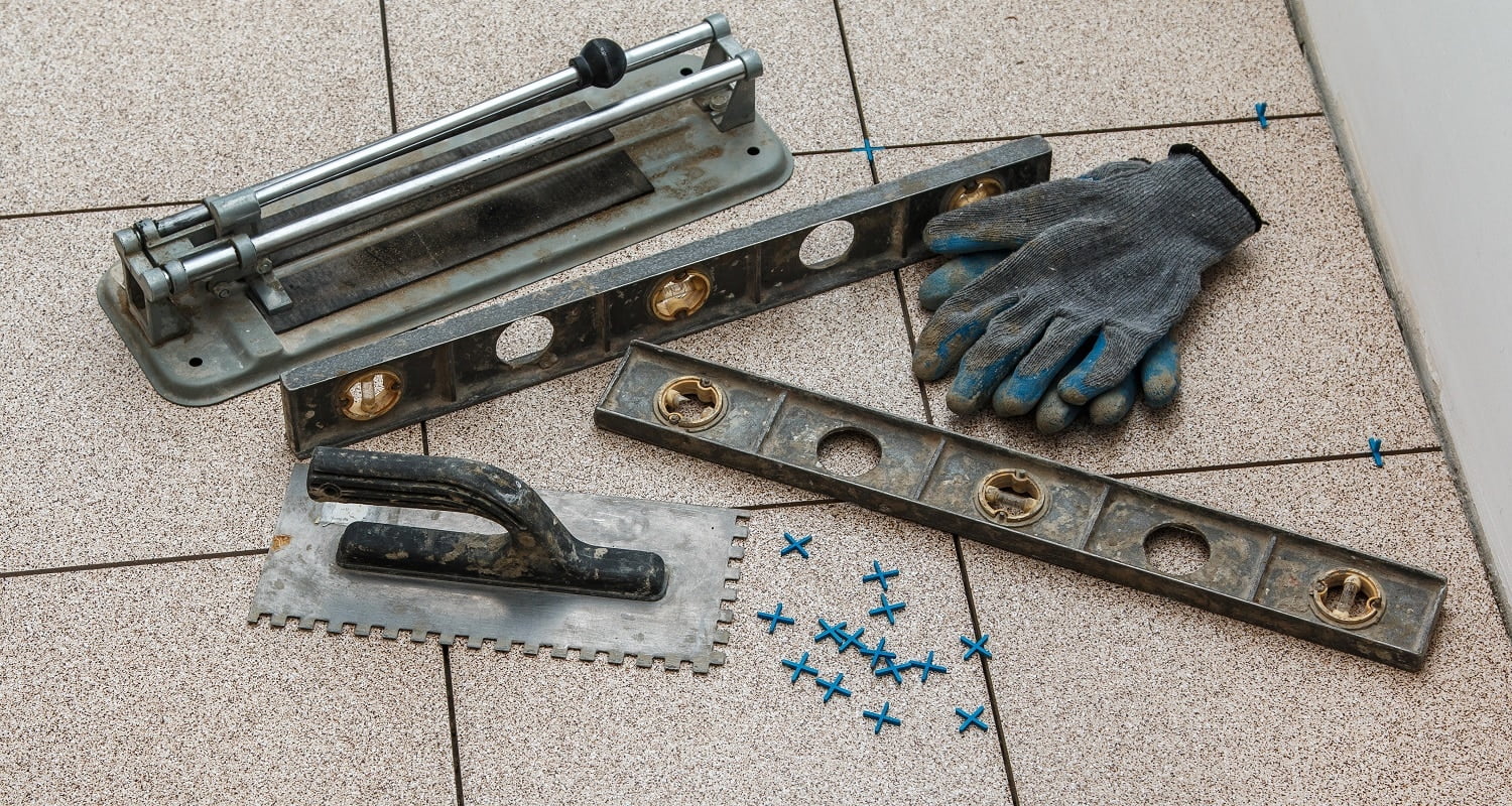 Installation of floor tiles. Ceramic tiles and different tools