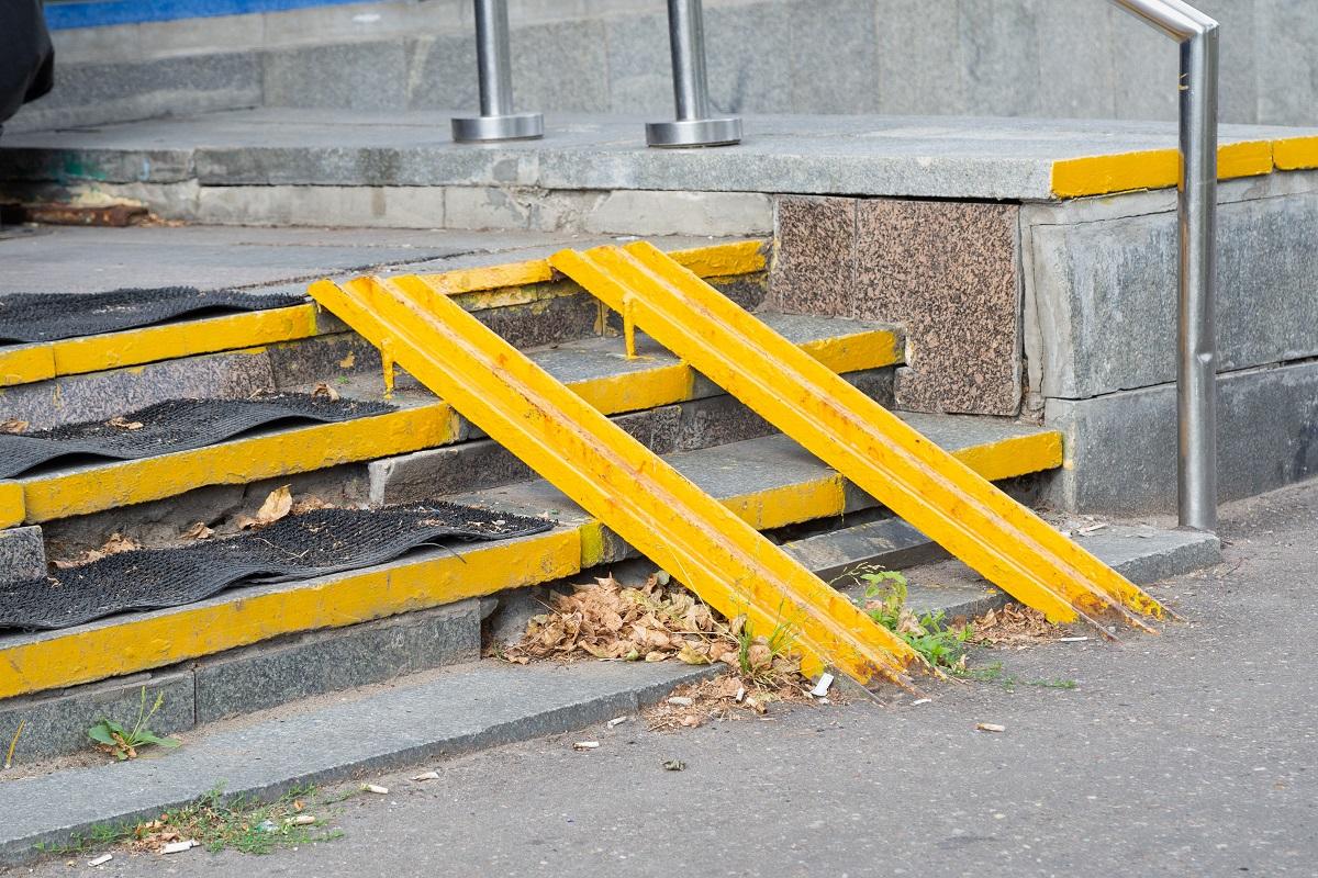 Yellow ramp on the stairs at the entrance of the house for the disabled or a baby carriage.