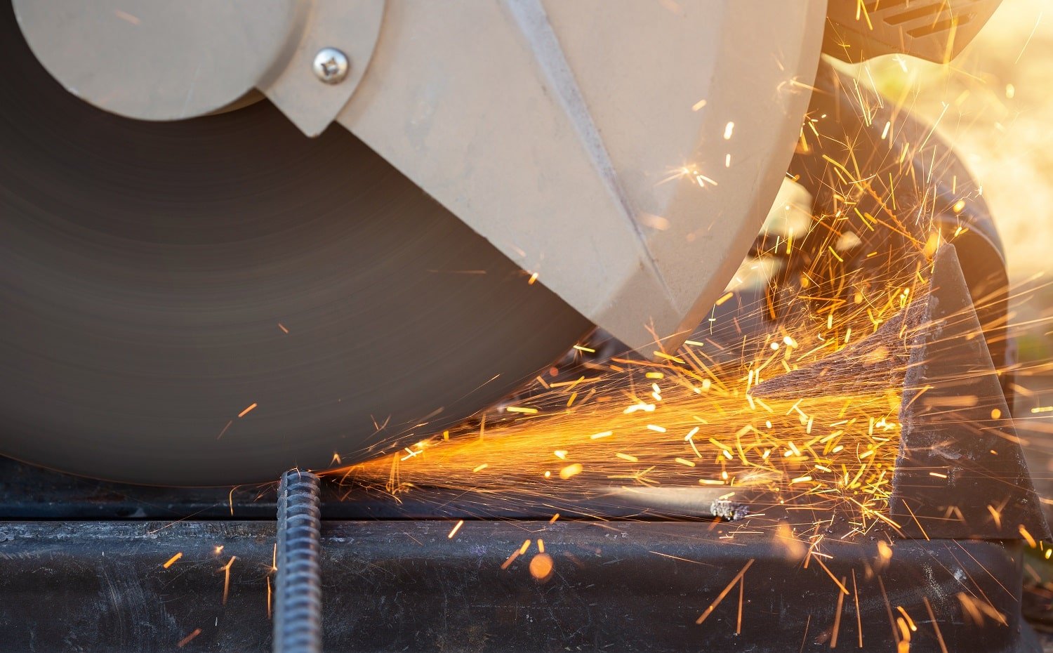 Close up machine while cutting rebar steel in construction site