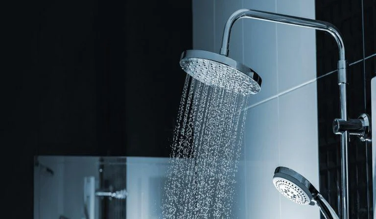 Close up of Water flowing from shower in the bathroom interior