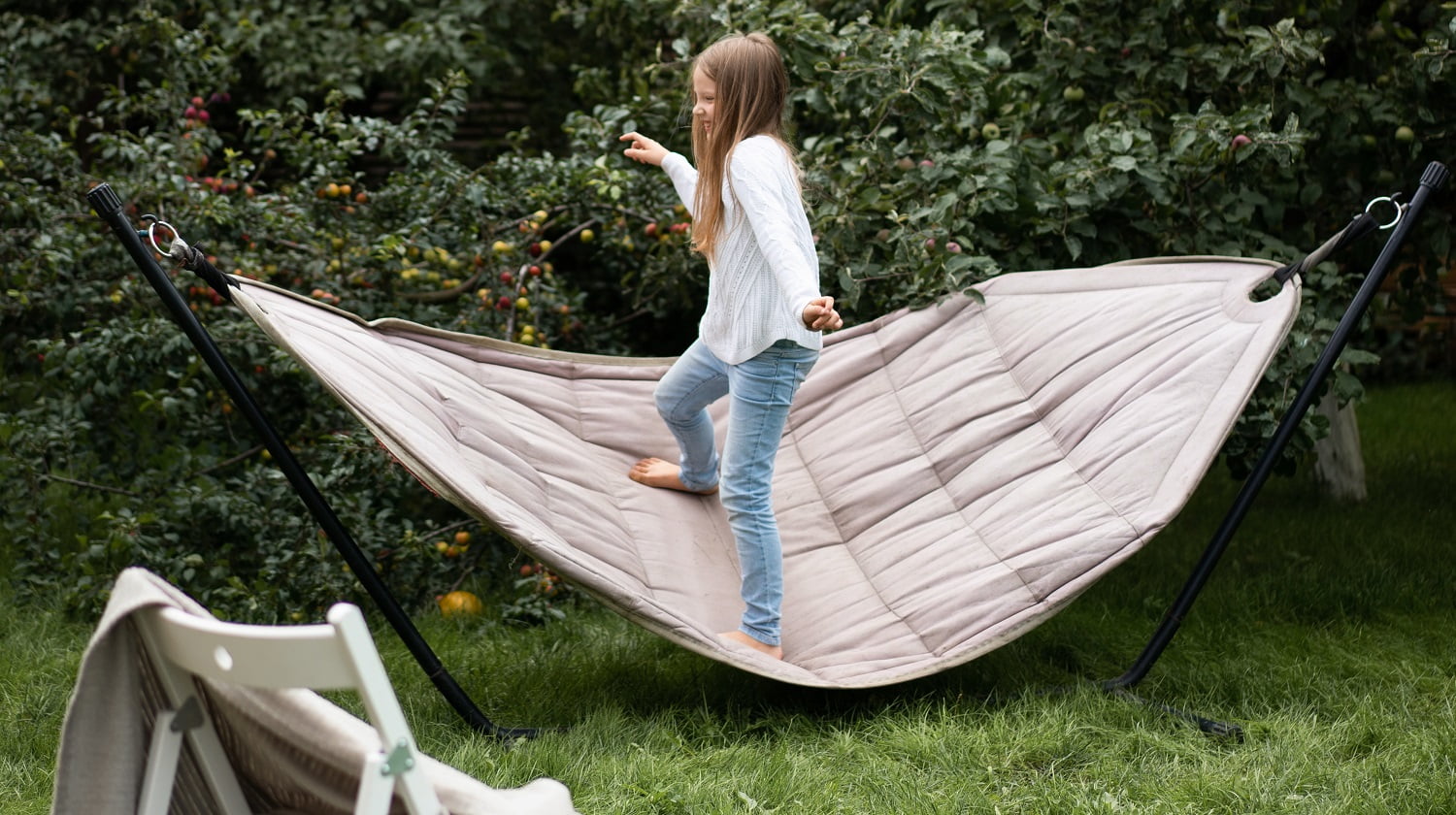 girl swinging standing in a hammock