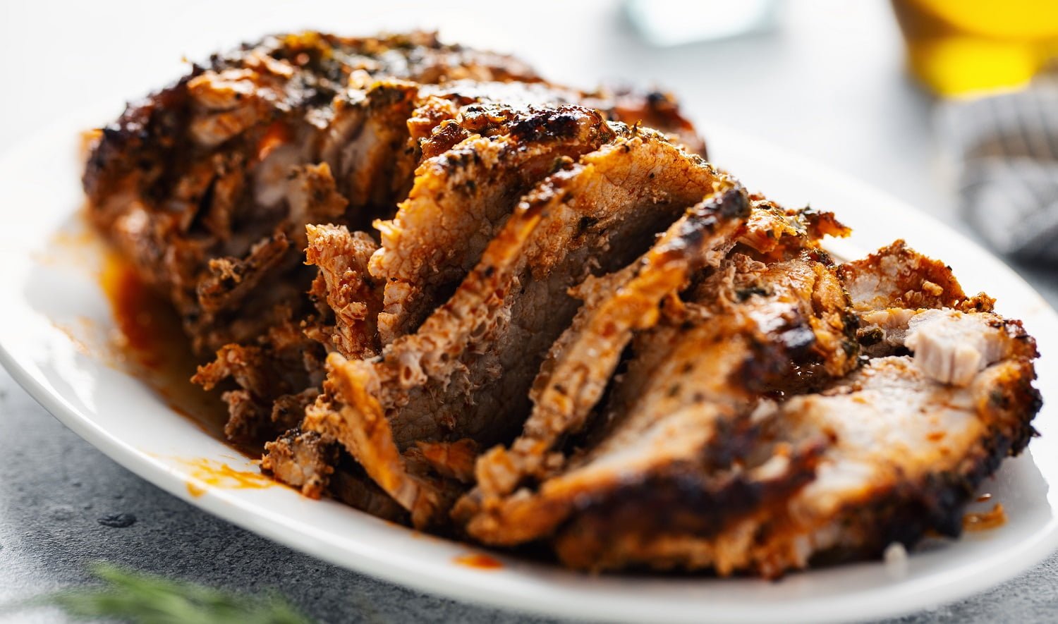 Tasty appetizing baked pork with spices and herbs. Closeup.