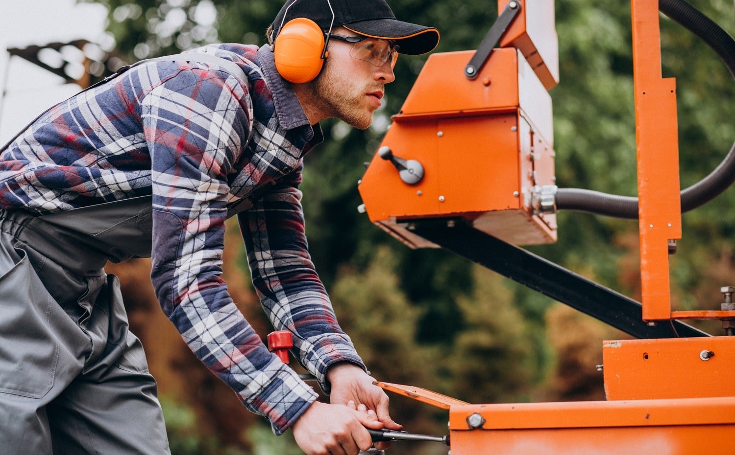 Carpenter working on a sawmill on a wood manufacture